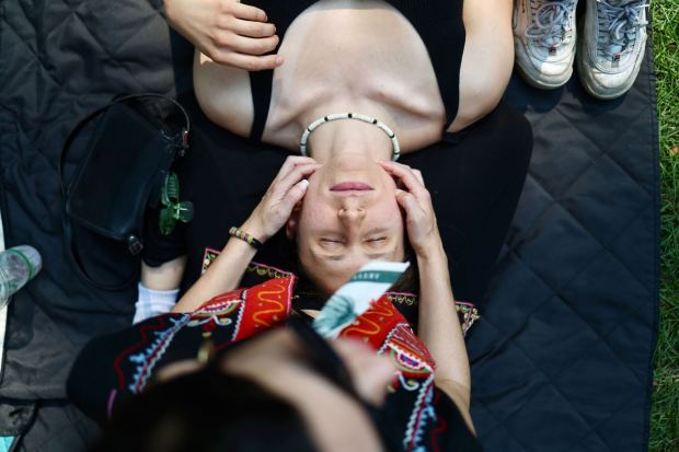 Jess Nickelman receives a face massage from Ezra Pelaez during Pitchfork Music Festival at Union Park, July 19, 2024, in Chicago. (John J. Kim/Chicago Tribune)