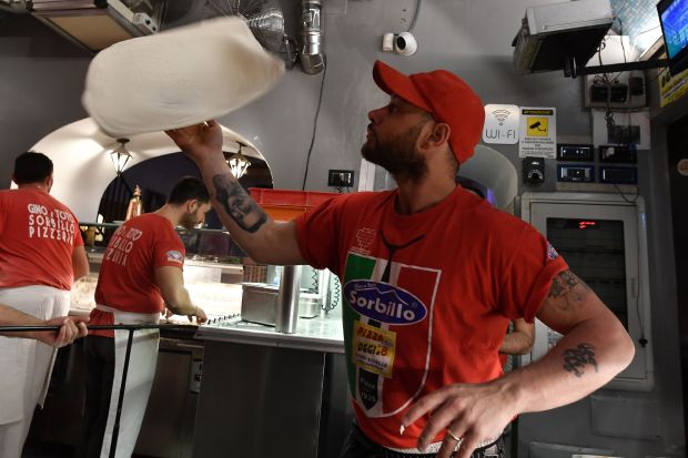 A pizza maker hand-tosses dough in Naples, Italy. (Tiziana Fabi/Getty-AFP)