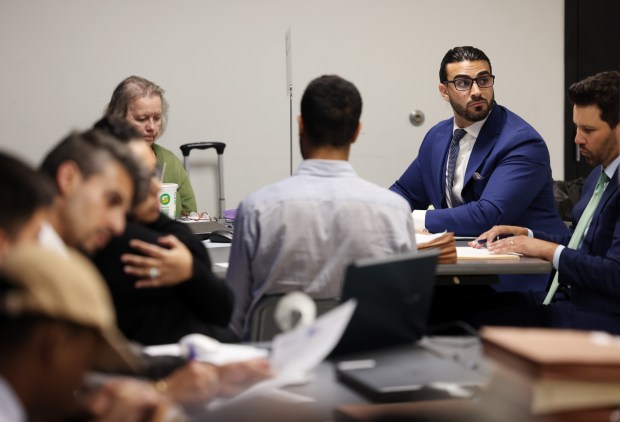 Jousef Shkoukani, school board candidate in the 5th District, second from right, attends an initial objections hearing for school board candidates at a Board of Elections meeting room at 69 W. Washington St. on July 9, 2024, in Chicago. (John J. Kim/Chicago Tribune)