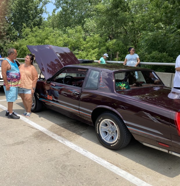 Esequiel Vasquez, Jr., and Lisa Perez- Vasquez talk outside their 1980 Chevrolet Monte at Scoop Waukegan. (Steve Sadin/For the Lake County News-Sun)