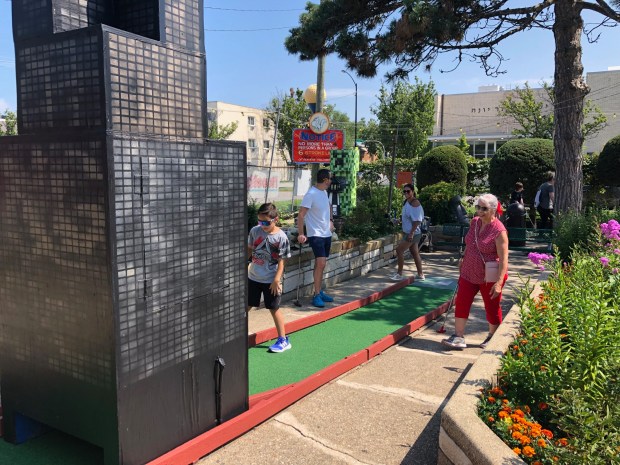 Edna Rivera of Chicago plays mini-golf at Novelty Golf/Bunny Hutch, a Lincolnwood institution celebrating 75 years in business, with family members visiting from out of town.