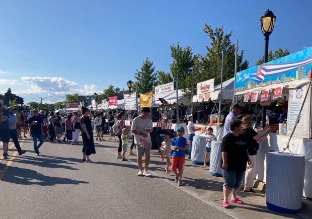 People stroll Taste of Park Ridge on July 18, 2024, looking at the food options. (Pam DeFiglio, Chicago Tribune/Pioneer Press)