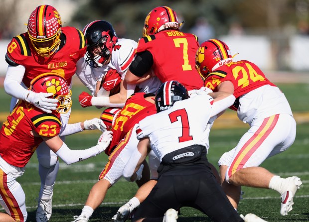 Batavia's Malachi Smith (8), Josh Kahley (23), Chase Osborne (20), RJ Bohr (7)and Ben Brown (34) swarm Lincoln-Way Central's Braden Meyer (4) during a Class 7A second-round playoff game in Batavia on Saturday, Nov. 4, 2023.