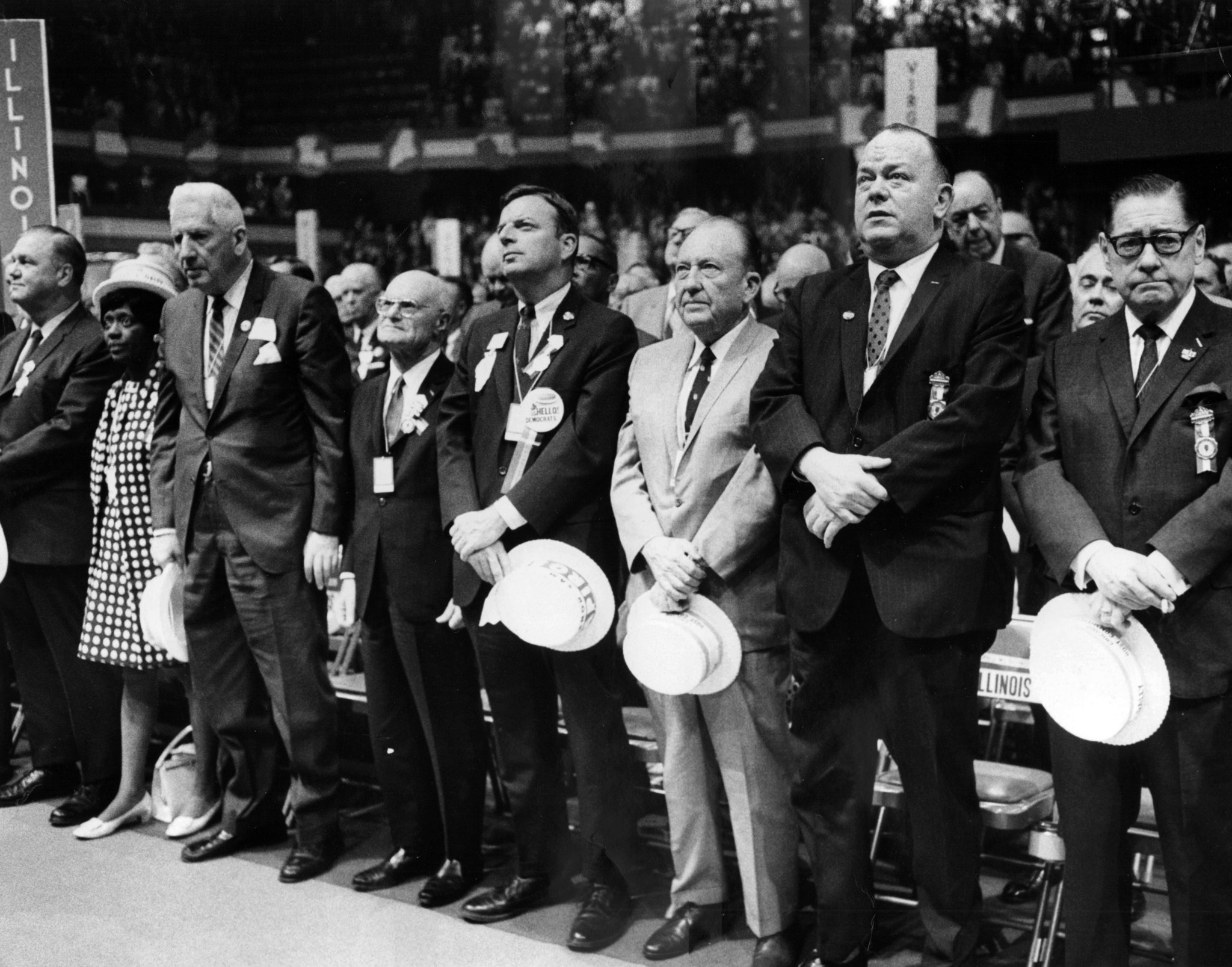 The Illinois delegation prays during opening day of the Democratic...