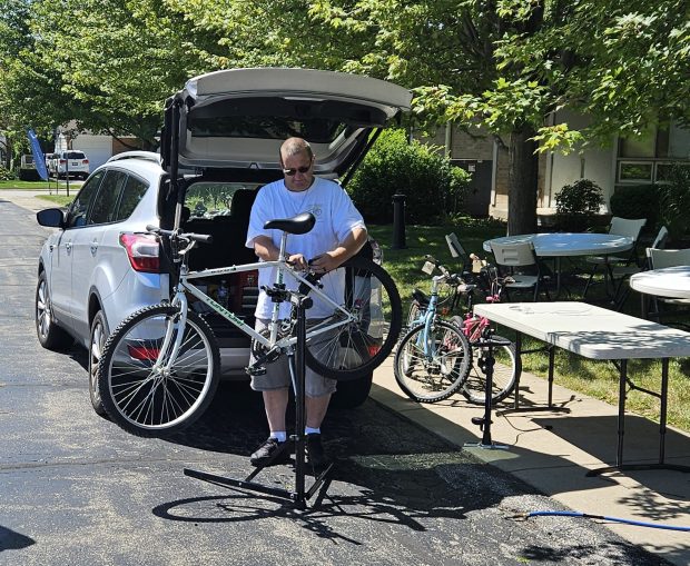 Aurora resident Pete Essling works on a bike Saturday during a free four-hour repair clinic at Community Christian Church in Aurora. (David Sharos / For The Beacon-News)