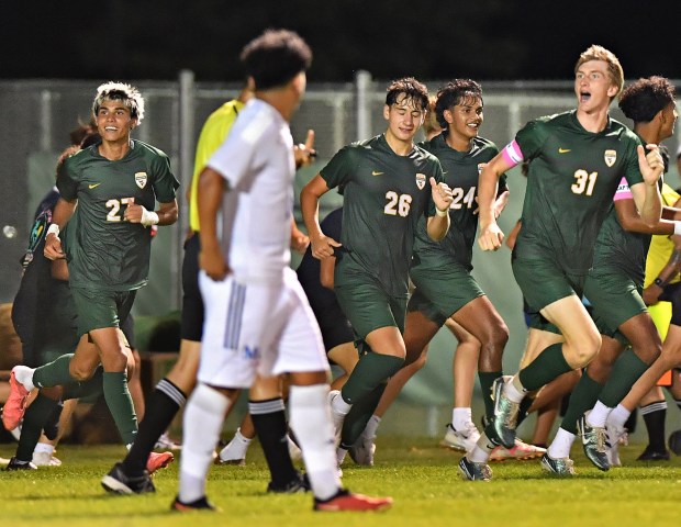 Waubonsie Valley's Cade Valek (31) celebrates with teammates after scoring the only goal of the game against Marmion on Thursday, Aug. 29, 2024 in Aurora...(Jon Cunningham/for The Beacon-News)