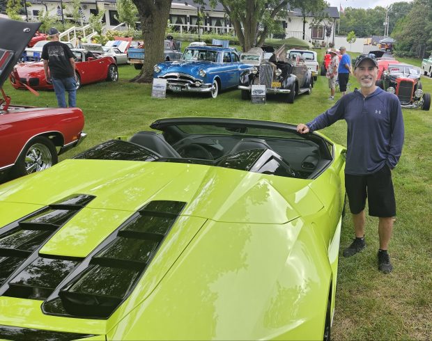 Brian Grysiewicz of Oswego showed off a 2023 Lamborghini at the car show Sunday at the Batavia Overseas VFW Post. (David Sharos / For The Beacon-News)