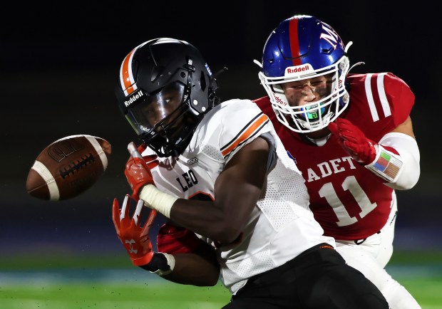 Marmion's Gavin Burt (11) breaks up a pass intended for Leo's Javon Logan (9)during a Chicago Catholic Conference game on Friday, Sept. 8, 2023 in Aurora. H. Rick Bamman / For the Beacon News