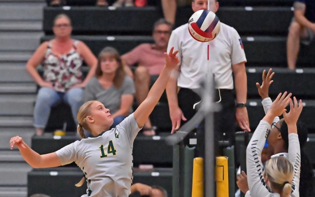 Waubonsie Valley's Ava Bellafiore volleys at the net with two Oswego East defenders. Oswego East defeated Waubonsie Valley in a girls volleyball game, Wednesday, Aug. 28, 2024, in Aurora, Illinois. (Jon Langham/for the Beacon-News)