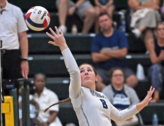 Oswego East's Jessica Lavigne hits a return shot over her shoulder. Oswego East defeated Waubonsie Valley in a girls volleyball game, Wednesday, Aug. 28, 2024, in Aurora, Illinois. (Jon Langham/for the Beacon-News)