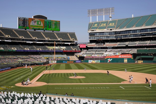 Chicago White Sox pitcher Lucas Giolito pitches to Oakland Athletics' Marcus Semien during the seventh inning of Game 1 of an American League wild-card baseball series Tuesday, Sept. 29, 2020, in Oakland, Calif. Due to pandemic restrictions there were only cardboard cutouts of fans in the stands. (AP Photo/Eric Risberg)