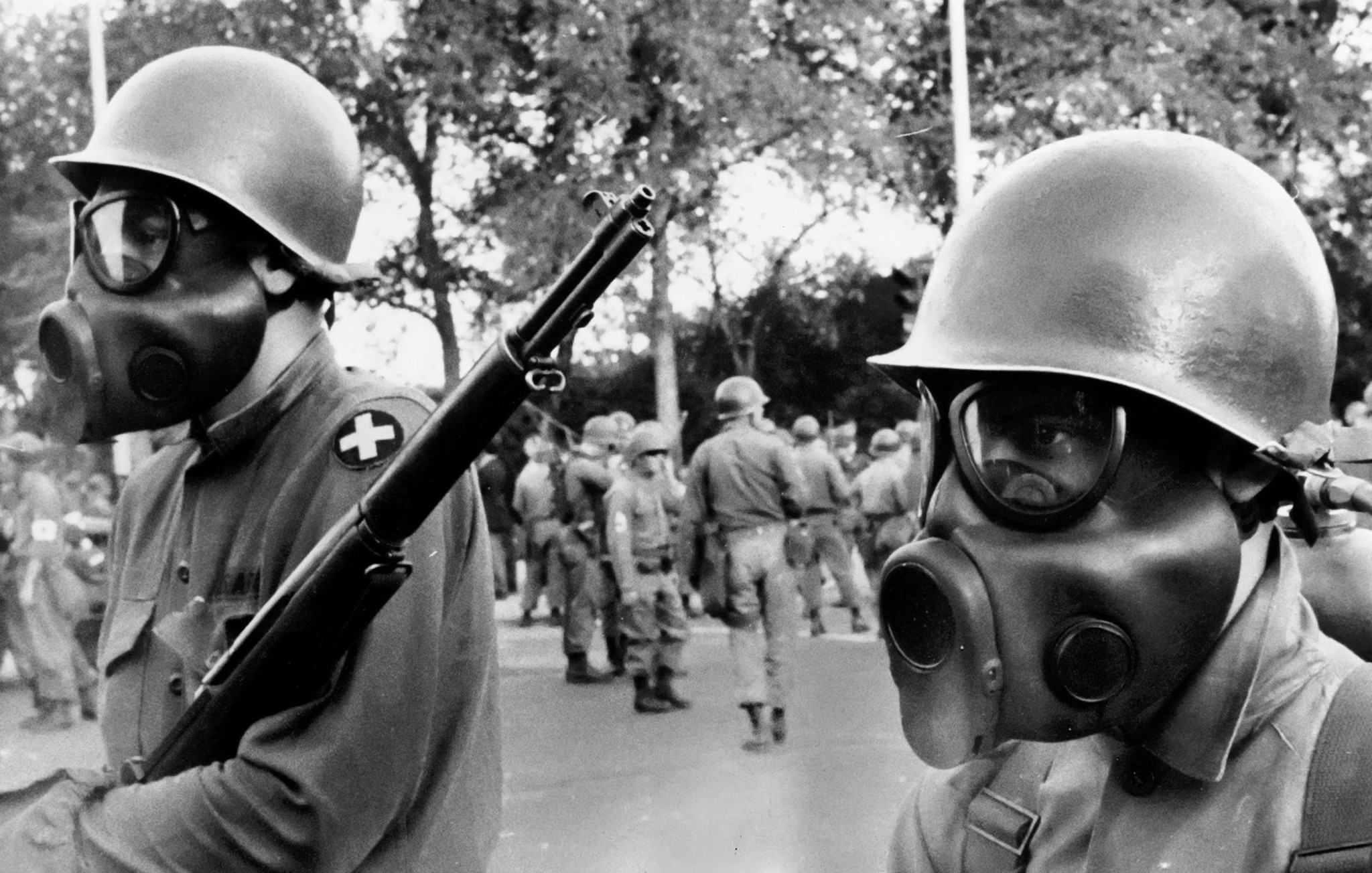 National Guardsmen donned gas masks before confronting anti-war protesters in...