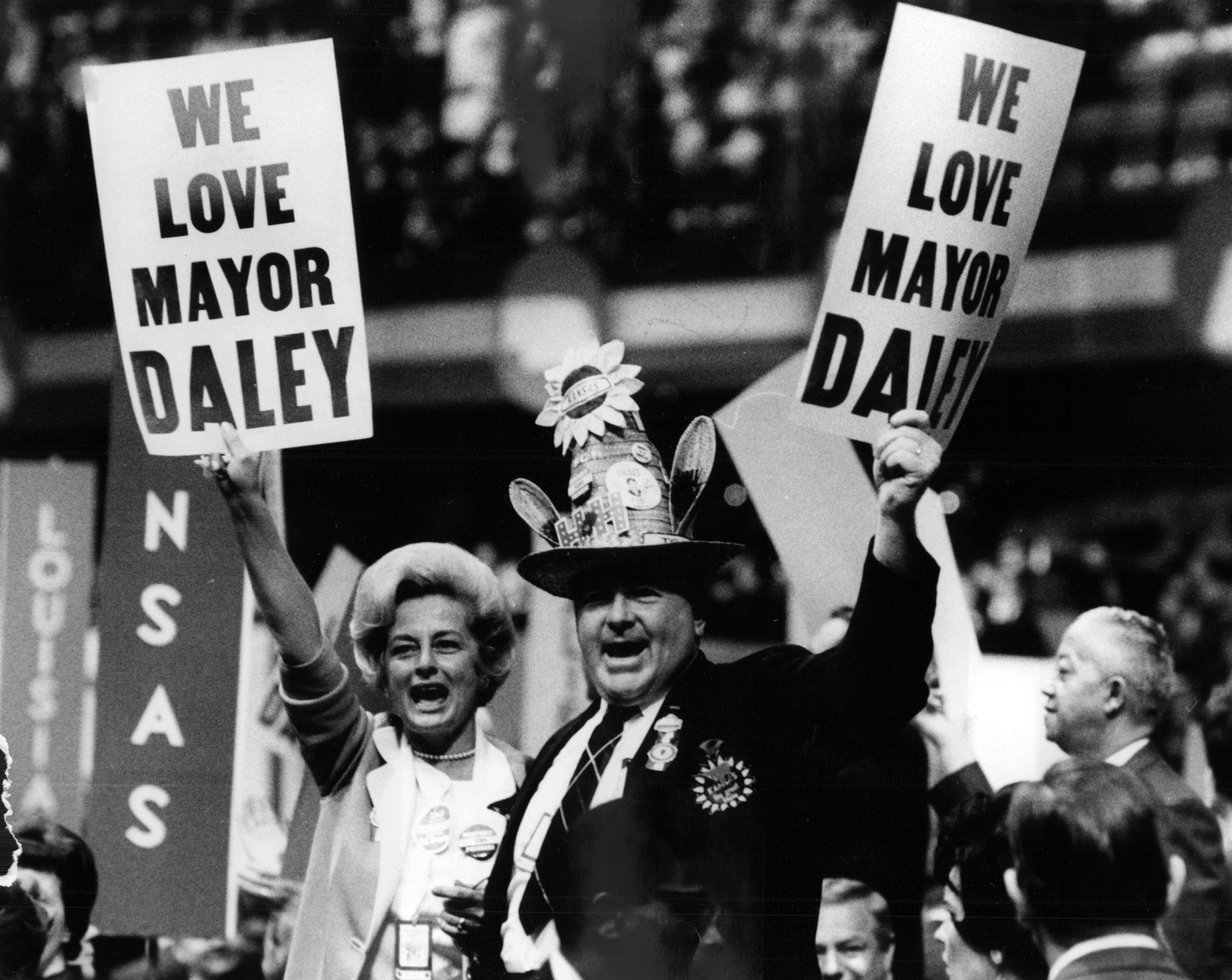 People hold signs that say "We love Mayor Daley" on...