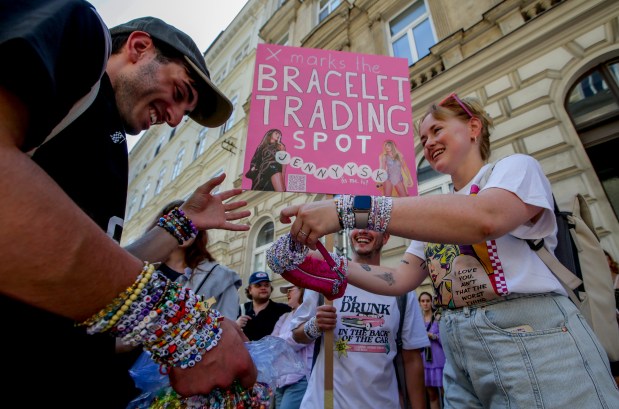 Swifties trade bracelets in the city center in Vienna on Aug. 8, 2024. Organizers of three Taylor Swift concerts in the stadium in Vienna this week called them off on Wednesday after officials announced arrests over an apparent plot to launch a terrorist attack at or near the event. (Heinz-Peter Bader/AP)