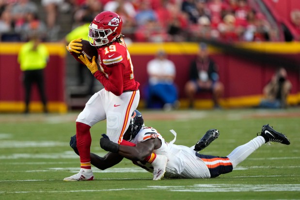 Chiefs wide receiver Kadarius Toney (19) catches a pass as Chicago Bears linebacker Amen Ogbongbemiga defends during the first half of an NFL preseason football game Thursday, Aug. 22, 2024, in Kansas City, Mo. (AP Photo/Charlie Riedel)