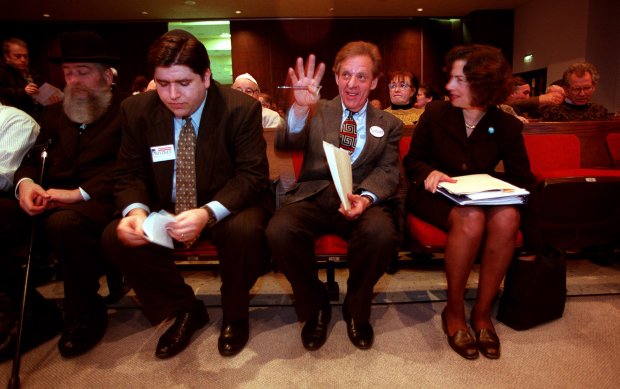 9th Congressional district candidates JB Pritzker, left, Howard Carroll, and Jan Schakowsky wait for their cue to step onto a stage at the beginning of a debate on Jan. 25, 1998, at the Ezra Habonim Synagogue in Skokie. (John Lee/Chicago Tribune)