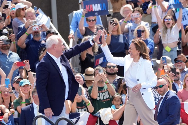 Democratic presidential nominee Vice President Kamala Harris is welcomed by Democratic vice presidential nominee Minnesota Gov. Tim Walz, before she delivers remarks at a campaign event, Wednesday, Aug. 7, 2024, in Eau Claire, Wisc. (AP Photo/Charles Rex Arbogast)