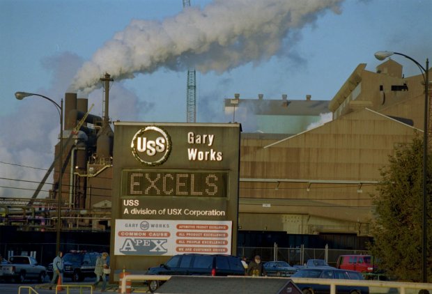 The U.S. Steel Gary Works belches smoke on Dec. 7, 1995, in Gary, Ind. The Gary Works, flagship of USX Corp., makes more steel than any other place in the nation. But the corporate giant, which once boasted four factories and 30,000 workers in Gary, has shrunk to one location with 7,800 employees --and many take paychecks home to nearby suburbs. (AP Photo/Michael S. Green)(steel industry) SEE CORRECTIONS FIELD ORG XMIT: NY331