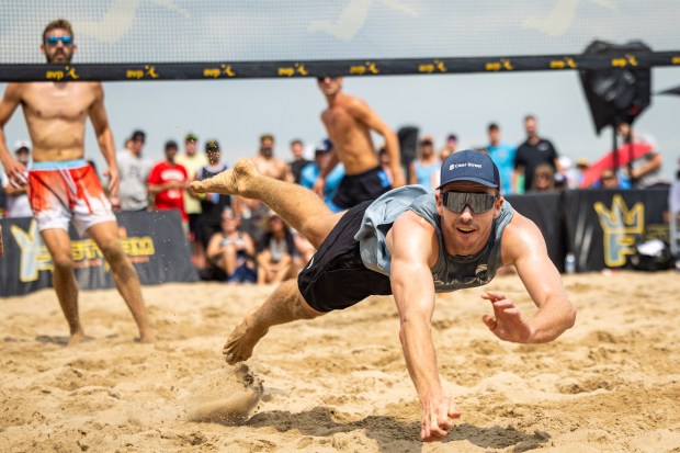 Andy Benesh dives for the ball in the AVP Chicago Open at Oak Street Beach in Chicago on Aug. 30, 2024. (Tess Crowley/Chicago Tribune)