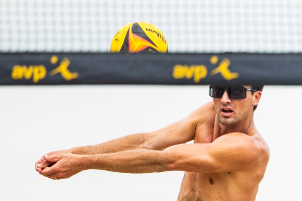 Jordan Hoppe spikes the ball in the AVP Chicago Open at Oak Street Beach in Chicago on Aug. 30, 2024. (Tess Crowley/Chicago Tribune)