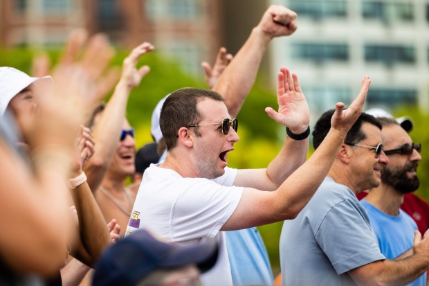 Fans cheer as David Wieczorek serves the ball in the AVP Chicago Open at Oak Street Beach in Chicago on Aug. 30, 2024. (Tess Crowley/Chicago Tribune)