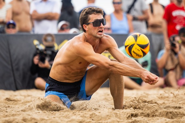 Jordan Hoppe lunges for the ball in the AVP Chicago Open at Oak Street Beach in Chicago on Aug. 30, 2024. (Tess Crowley/Chicago Tribune)