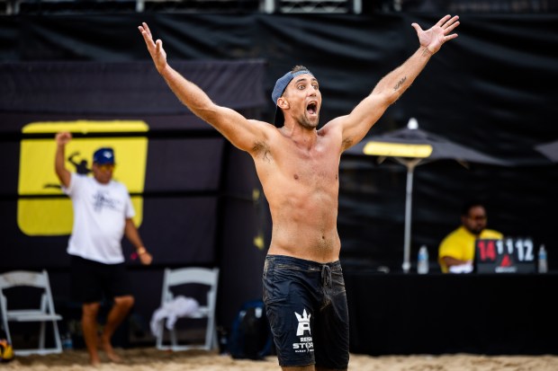 Trevor Crabb celebrates after scoring a point in the AVP Chicago Open at Oak Street Beach in Chicago on Aug. 30, 2024. (Tess Crowley/Chicago Tribune)