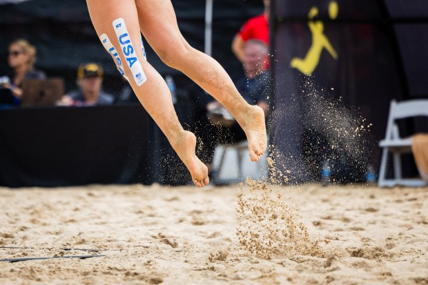 Sarah Hughes serves in the AVP Chicago Open at Oak Street Beach in Chicago on Aug. 30, 2024. (Tess Crowley/Chicago Tribune)