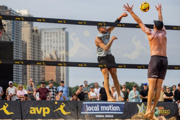 Miles Partain spikes the ball in the AVP Chicago Open at Oak Street Beach in Chicago on Aug. 30, 2024. (Tess Crowley/Chicago Tribune)