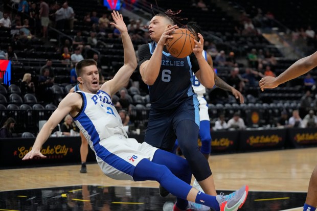 Grizzlies forward Kenneth Lofton Jr. drives as 76ers center Filip Petrusev falls during an NBA Summer League game on July 3, 2023, in Salt Lake City. (AP Photo/Rick Bowmer)