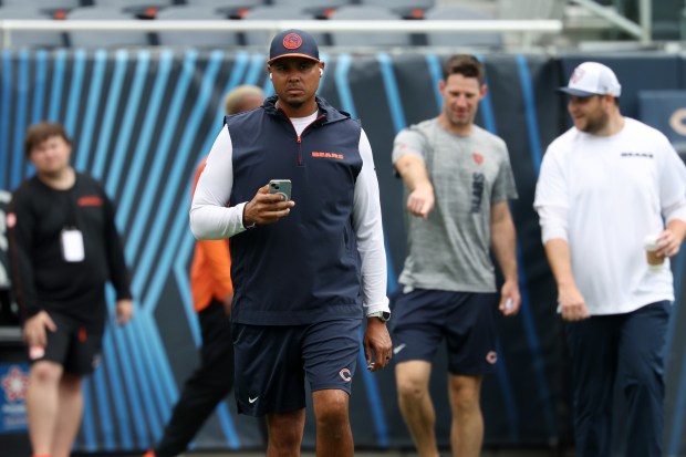 Bears general manager Ryan Poles, center left, walks the perimeter of the field before a preseason game against the Bengals at Soldier Field on Aug. 17, 2024, in Chicago. (John J. Kim/Chicago Tribune)