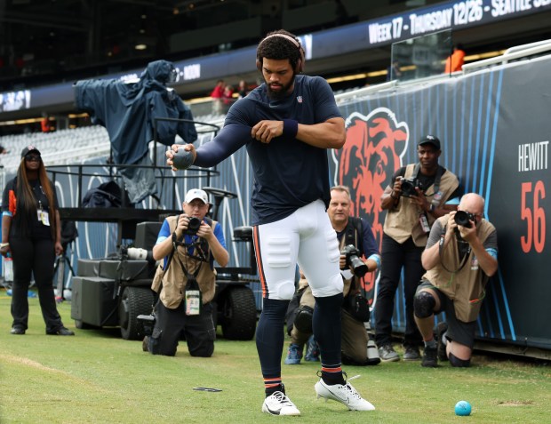 Photographers wait for Bears quarterback Caleb Williams to begin stretching for a preseason game against the Bengals at Soldier Field on Aug. 17, 2024. (John J. Kim/Chicago Tribune)