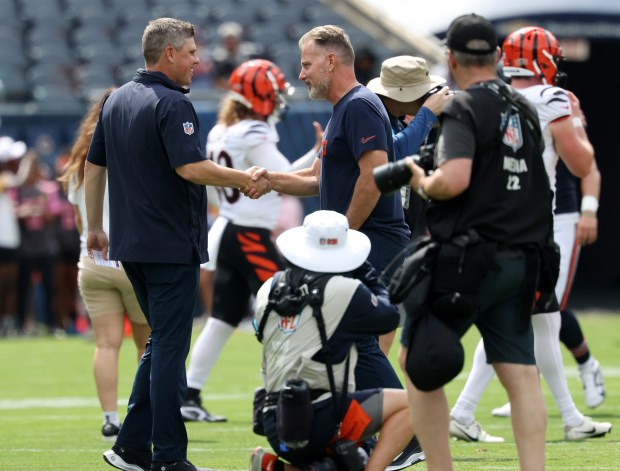 Bears offensive coordinator Shane Waldron, left, greets head coach Matt Eberflus before a preseason game against the Bengals at Soldier Field on Aug. 17, 2024, in Chicago. (John J. Kim/Chicago Tribune)