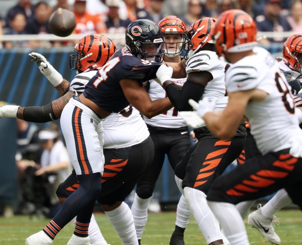 Bears defensive lineman Austin Booker (94) is held in the first quarter against the Bengals in a preseason game at Soldier Field on Aug. 17, 2024, in Chicago. (John J. Kim/Chicago Tribune)