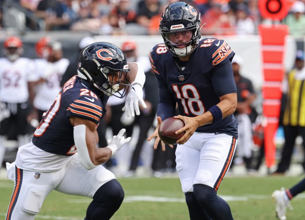 Bears quarterback Caleb Williams (18) fakes a handoff to running back Travis Homer (20) in the second quarter against the Bengals in a preseason game at Soldier Field on Aug. 17, 2024, in Chicago. (John J. Kim/Chicago Tribune)