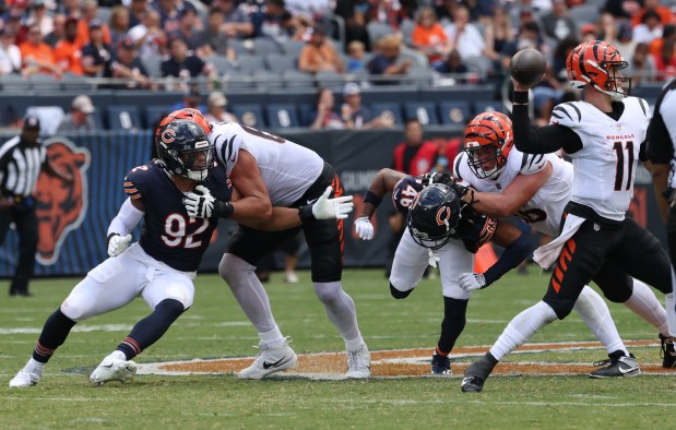 Bears defensive end Daniel Hardy (92) chases Bengals quarterback Logan Woodside (11) in the third quarter of a preseason game at Soldier Field on Aug. 17, 2024, in Chicago. (John J. Kim/Chicago Tribune)