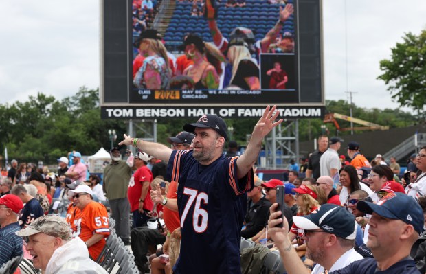 A Bears fan wearing a Steve McMichael jersey celebrates during the Pro Football Hall of Fame enshrinement ceremony at Tom Benson Hall of Fame Stadium on Aug. 3, 2024, in Canton. (John J. Kim/Chicago Tribune)