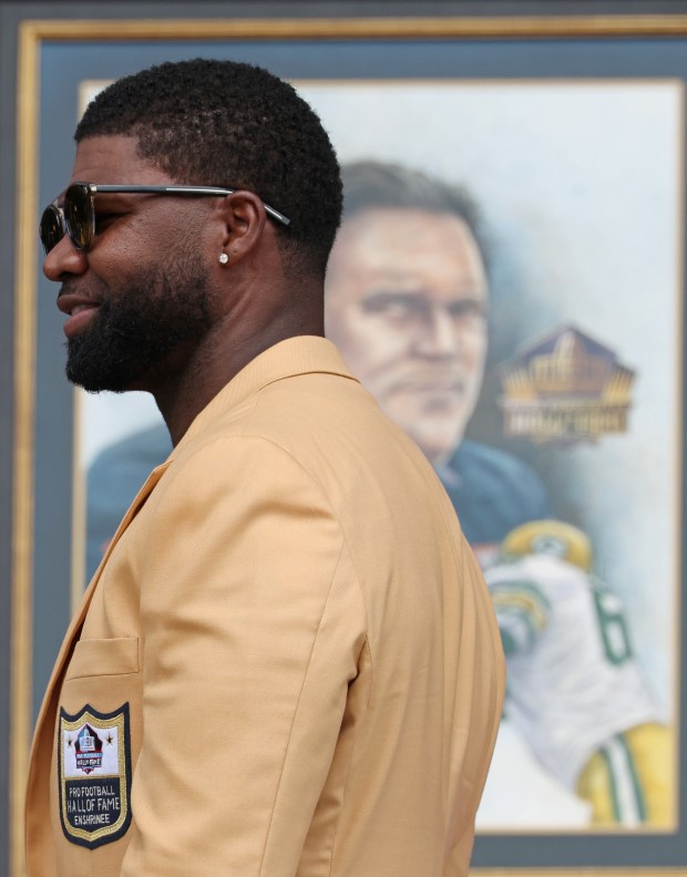 Devin Hester stands in front of a portrait of Steve McMichael during the Pro Football Hall of Fame enshrinement ceremony at Tom Benson Hall of Fame Stadium on Aug. 3, 2024, in Canton. (John J. Kim/Chicago Tribune)