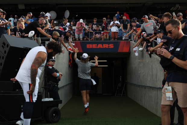 Bears quarterback Tyson Bagent high-fives fans after warming up for the Hall of Fame Game against the Texans at Tom Benson Hall of Fame Stadium on Aug. 1, 2024. (John J. Kim/Chicago Tribune)