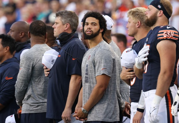 Bears quarterback Caleb Williams, center, stands for the national anthem with teammates before the Hall of Fame Game against the Texans at Tom Benson Hall of Fame Stadium on Aug. 1, 2024, in Canton. (John J. Kim/Chicago Tribune)