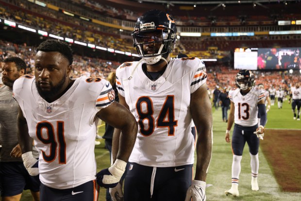 Bears defensive end Yannick Ngakoue (91) and tight end Marcedes Lewis (84) prepare for a game against the Commanders on Oct. 5, 2023, at FedEx Field. (Brian Cassella/Chicago Tribune)