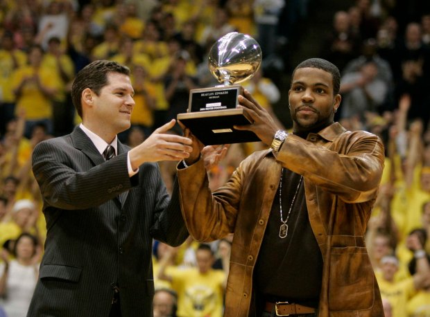 The Chicago Tribune's Teddy Greenstein presents Michigan's Braylon Edwards with the Silver Football award on Feb. 8, 2005, in Ann Arbor, Michigan. (Jim Prisching/Chicago Tribune)