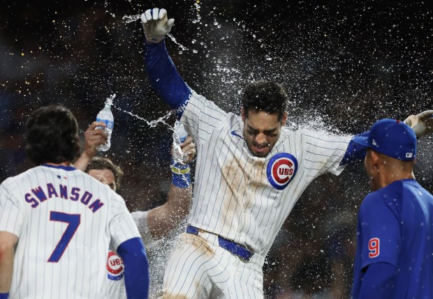 Cubs designated hitter Mike Tauchman is doused with water by teammates after hitting a walk-off home run for a 7-6 win over the White Sox on June 5, 2024, at Wrigley Field. (John J. Kim/Chicago Tribune)