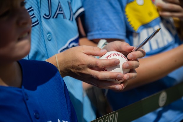 Children wait for autographs from Cubs players before the Cubs play against the Toronto Blue Jays at Wrigley Field in Chicago on Aug. 16, 2024. The Cubs won 6-5 against the Toronto Blue Jays. (Tess Crowley/Chicago Tribune)