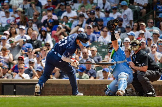 Toronto Blue Jays starting pitcher Yariel Rodríguez (29) throws a ball above Chicago Cubs designated hitter Seiya Suzuki (27)'s head in the third inning against the Toronto Blue Jays at Wrigley Field in Chicago on Aug. 16, 2024. The Cubs won 6-5 against the Toronto Blue Jays. (Tess Crowley/Chicago Tribune)