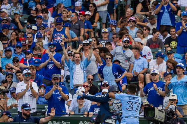 Fans cheer after Toronto Blue Jays shortstop Leo Jiménez (49) hits a solo home run bringing the score to 2-2 in the fifth inning at Wrigley Field in Chicago on Aug. 16, 2024. The Cubs won 6-5 against the Toronto Blue Jays. (Tess Crowley/Chicago Tribune)