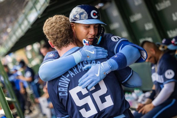 Chicago Cubs catcher Miguel Amaya (9) hugs Chicago Cubs center fielder Pete Crow-Armstrong (52) after both players hit home runs in the 5th inning against the Toronto Blue Jays at Wrigley Field in Chicago on Aug. 16, 2024. The Cubs won 6-5 against the Toronto Blue Jays. (Tess Crowley/Chicago Tribune)