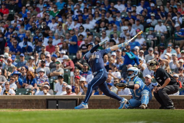 Chicago Cubs left fielder Ian Happ (8) hits a home run in the seventh inning against the Toronto Blue Jays at Wrigley Field in Chicago on Aug. 16, 2024. The Cubs won 6-5 against the Toronto Blue Jays. (Tess Crowley/Chicago Tribune)