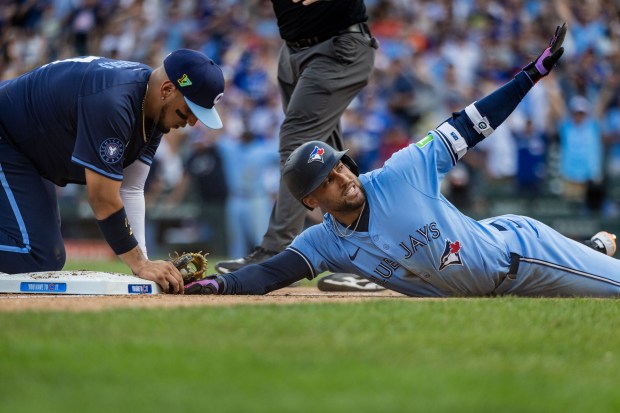 Blue Jays right fielder George Springer slides safely into third base after his two-run single in the eighth inning tied the game against the Cubs at 5-5 on Friday at Wrigley Field. (Tess Crowley/Chicago Tribune)