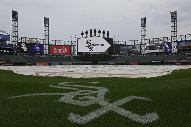 The rain tarp is placed over the infield before a game between the White Sox and Rockies at Guaranteed Rate Field on June 28, 2024, in Chicago. (John J. Kim/Chicago Tribune)